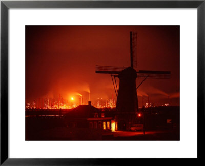 Lights And Fires Of Pernis Refinery Glowing Behind Silhouetted Windmill by Ralph Crane Pricing Limited Edition Print image