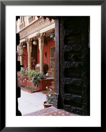 Traditional Wood Door And 19Th Century Floor Tiles In Restored Traditional Pol House by John Henry Claude Wilson Pricing Limited Edition Print image