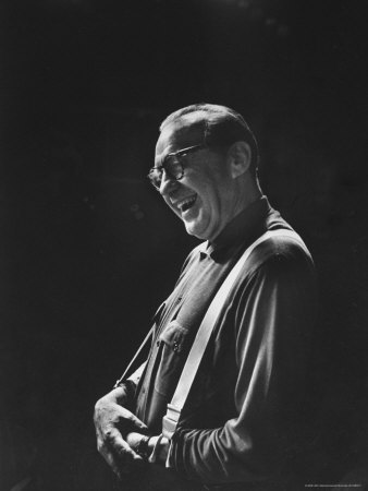 Comedian Jack Benny Laughing As He Stands Alone Under Tv Lights At Studio During Rehearsal by Leonard Mccombe Pricing Limited Edition Print image