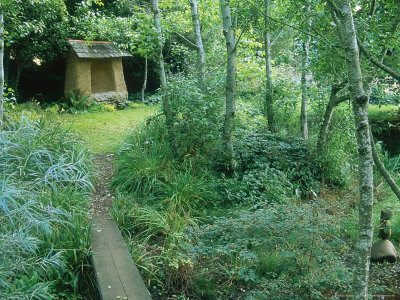 Small Stone Arbour In Clearing In Woodland, Narrow Plank Bridge, Stone Lane Gardens, Devon by Mark Bolton Pricing Limited Edition Print image