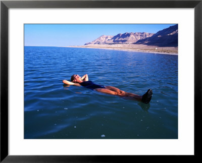 Woman Floating In Dead Sea Waters, Israel by Lee Foster Pricing Limited Edition Print image