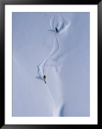Skiers Carve Through Deep Powder In The Selkirk Mountains by Paul Chesley Pricing Limited Edition Print image