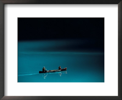 A Canoe Plies The Mirror-Smooth Surface Of Lake Louise by Raymond Gehman Pricing Limited Edition Print image