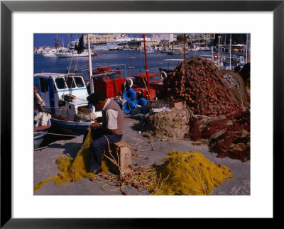 Fisherman Mending His Nets On Waterfront In Herakleion, Greece by Wayne Walton Pricing Limited Edition Print image