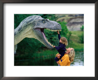 Woman Holding A Girl Up To A Dinosaur Model, Drumheller Valley, Alberta, Canada by Philip & Karen Smith Pricing Limited Edition Print image