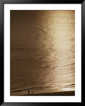 Two Silhouetted Figures On A Marco Island Beach At Sunset by Raul Touzon Pricing Limited Edition Print image