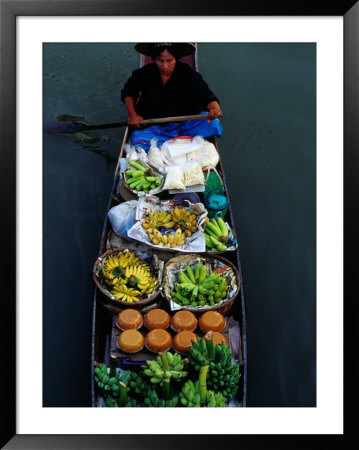 Woman Paddling Wooden Canoe Laden With Fruit For Sale At Floating Market, Damnoen Saduak, Thailand by Richard I'anson Pricing Limited Edition Print image