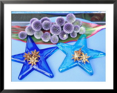 Arrangement Of Star Anise On Glass Star Shaped Tiles, On Blue Table With Echinops Ritro by Linda Burgess Pricing Limited Edition Print image