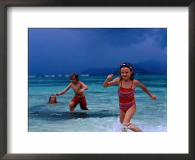 Children Running Out Of Ocean In Stormy Weather, Seychelles by Philip & Karen Smith Pricing Limited Edition Print image