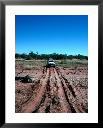 Landrover Driving Over Dry River Bed, Matusadona National Park, Mashonaland West, Zimbabwe by Tony Wheeler Pricing Limited Edition Print image