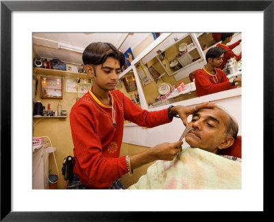 Young Man Shaving Older Man In Indian Barber Shop, Dar Es Salaam, Tanzania by Ariadne Van Zandbergen Pricing Limited Edition Print image