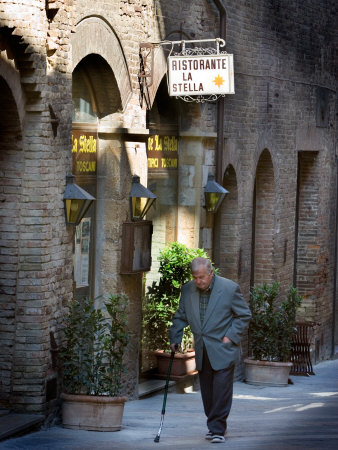 Elderly Gentleman Walking Down Streets Of San Gimignano, Italy by Robert Eighmie Pricing Limited Edition Print image