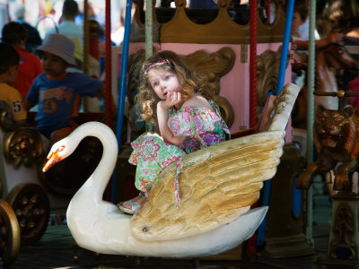 Girl On A Carousel At The Flea-Market Festival, Vence, France by Robert Eighmie Pricing Limited Edition Print image