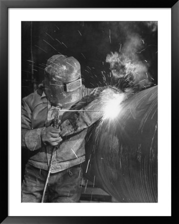 Worker Welding Pipe Used In Natural Gas Pipeline At World's Biggest Coal Fueled Generating Plant by Margaret Bourke-White Pricing Limited Edition Print image