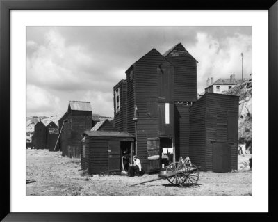 Clustered On The Shingle Of The Old Town Of Hastings Sussex Are These Tall Black Huts by Fred Musto Pricing Limited Edition Print image