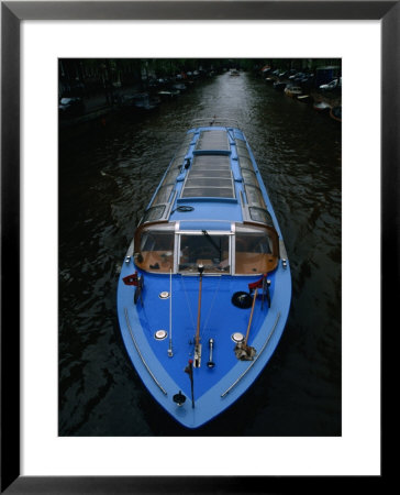 Blue Canal Tour Boat On Canal, Amsterdam, North Holland, Netherlands by Martin Moos Pricing Limited Edition Print image