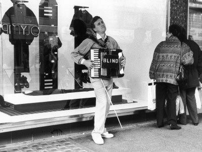 A Blind Busker On Oxford Street, London by Shirley Baker Pricing Limited Edition Print image