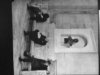 Men Sleeping On Stone Bench Below Bust Of Architect John M. Carrere In New York Public Library by Alfred Eisenstaedt Pricing Limited Edition Print image