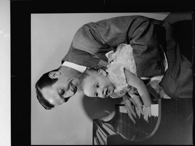 Harry James At Piano, Holding Daughter As She Plays On The Keys At Her Birthday Celebration by Peter Stackpole Pricing Limited Edition Print image