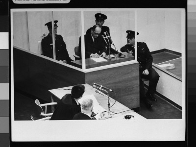 Nazi War Criminal Adolf Eichmann Sitting In Glass Booth Surrounded By Guards by Gjon Mili Pricing Limited Edition Print image