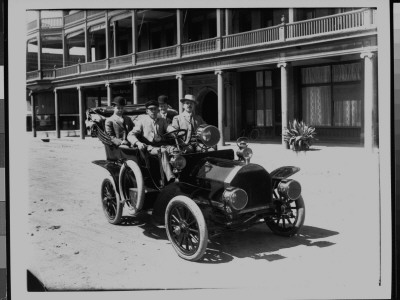Group Of Men Sitting In Government Automobile, In Front Of Adams Hotel by W.J. Lubken Pricing Limited Edition Print image