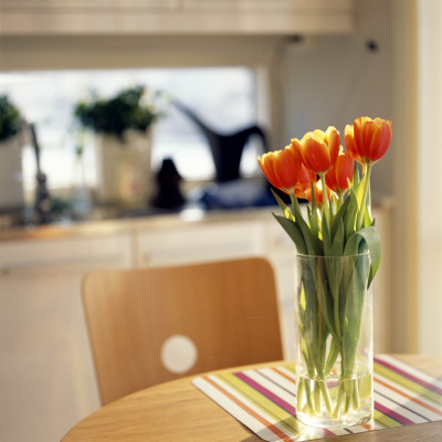 Orange Tulips In A Vase On A Table by Mikael Bertmar Pricing Limited Edition Print image