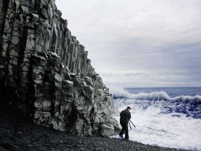 A Person Standing By Columnar Basalt By The Sea, South Iceland by Atli Mar Pricing Limited Edition Print image
