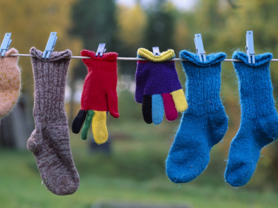 Woolen Socks And Gloves Drying On A Clothesline by Bengt-Goran Carlsson Pricing Limited Edition Print image