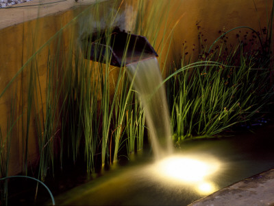 Water Feature: Rendered Concrete Water Rill With Spout Lit Up At Night, Designer: Mark Laurence by Clive Nichols Pricing Limited Edition Print image