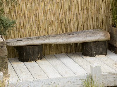 Wooden Driftwood Seat On Decking In Seaside Garden, Boardwalk, Designer: Nigel Duff And Greg Riddle by Clive Nichols Pricing Limited Edition Print image