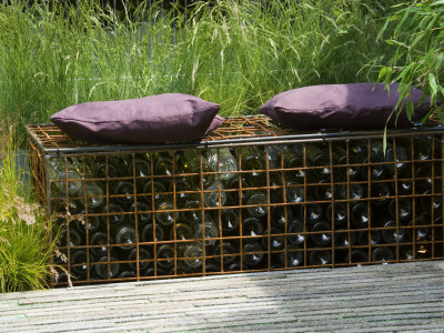 Purple Cushions On Steel Cage Seat Made From Gabions Filled With Bottles, (Chelsea 2005) by Clive Nichols Pricing Limited Edition Print image