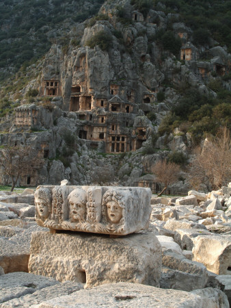 Frieze Of Stone Masks From Ancient Theatre With Rock-Cut Tombs In Background, Myra by Natalie Tepper Pricing Limited Edition Print image