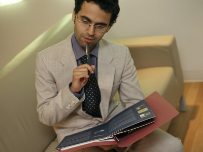 Office Life And Interiors, Office Worker Sitting On Sofa by Nicholas Kane Pricing Limited Edition Print image