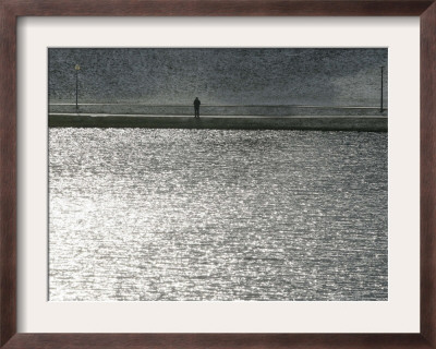 A Man Stands On The Banks Of A Small Lake, Munich, On Friday, November 3, 2006. by Christof Stache Pricing Limited Edition Print image