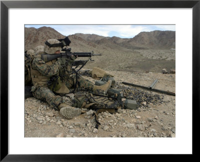 A Marine Rifleman Provides Security For Machine Gunners Atop A Hill by Stocktrek Images Pricing Limited Edition Print image