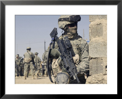 Us Army Soldier Armed With A Mk 48 Light Machine Gun, Provides Rear Security During Civil Affairs by Stocktrek Images Pricing Limited Edition Print image