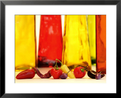 Various Types Of Peppers In Front Of Red & Yellow Bottles by Monica Varella Pricing Limited Edition Print image