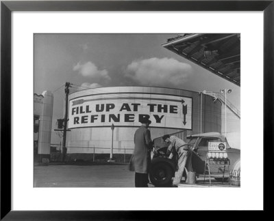 Gas Station Attendant Changing Oil For A Customer Next To Fill Up At The Refinery Sign by Margaret Bourke-White Pricing Limited Edition Print image