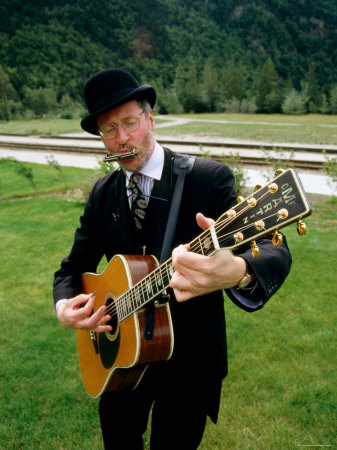 Man Playing A Guitar And Mouth Organ, Skagway, Alaska by Lee Foster Pricing Limited Edition Print image