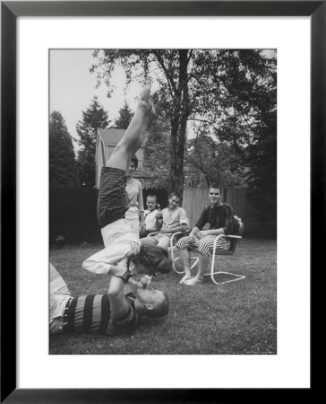 Berta De Fazio Eating Ice Cream From Reb Moore's Mouth In A Handstand by Joe Scherschel Pricing Limited Edition Print image