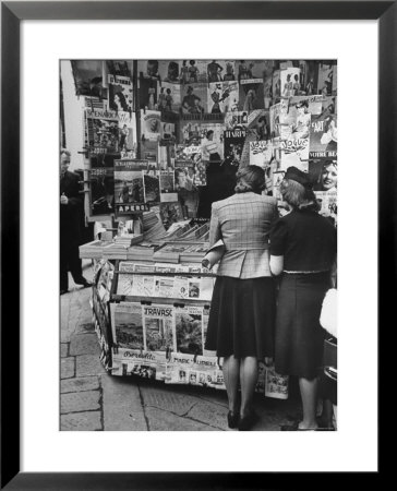 Women Browsing Through The Newspaper And Magazine Stand by Carl Mydans Pricing Limited Edition Print image