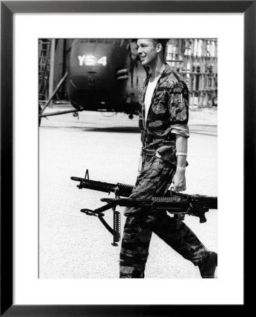 Yankee Papa 13 Helicopter Crew Chief James Farley Carrying A Pair Of M-60 Machine Guns by Larry Burrows Pricing Limited Edition Print image