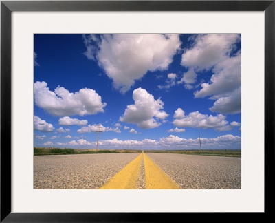 Cumulus Clouds In Blue Summer Sky Over Paved Road by John Eastcott & Yva Momatiuk Pricing Limited Edition Print image