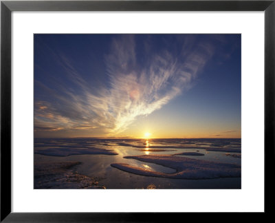 Wispy Clouds And Melting Ice At Sunet In An Arctic Landscape by Paul Nicklen Pricing Limited Edition Print image