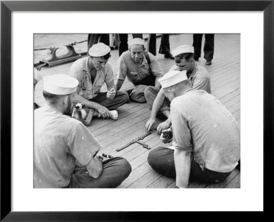 Sailors Aboard A Us Navy Cruiser At Sea Playing A Game Of Dominoes On Deck During Wwii by Ralph Morse Pricing Limited Edition Print image