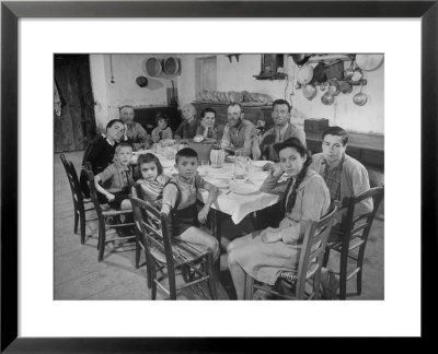 Portrait Of A Family Of Tuscan Tennat Farmers Sitting Around Dinner Table by Alfred Eisenstaedt Pricing Limited Edition Print image