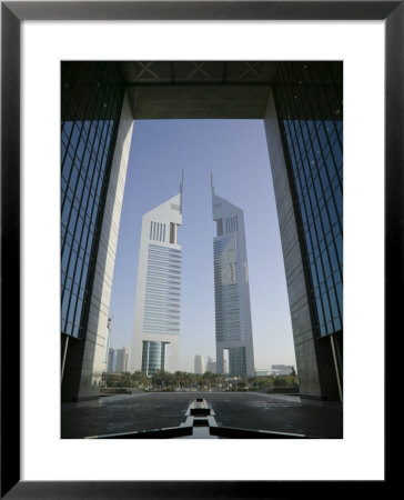 Emirates Towers Through Dubai International Financial Center Arch, Sheikh Zayed Road, Dubai, Uae by Walter Bibikow Pricing Limited Edition Print image