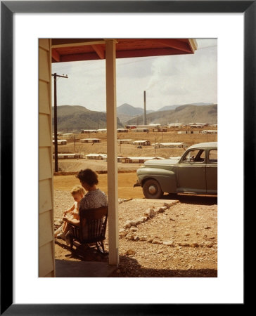 Woman Sitting In Rocking Chair On Veranda Playing With Baby On Her Lap by Andreas Feininger Pricing Limited Edition Print image