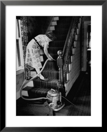 Housewife Cleaning Her Carpet With Vacuum Cleaners by Yale Joel Pricing Limited Edition Print image
