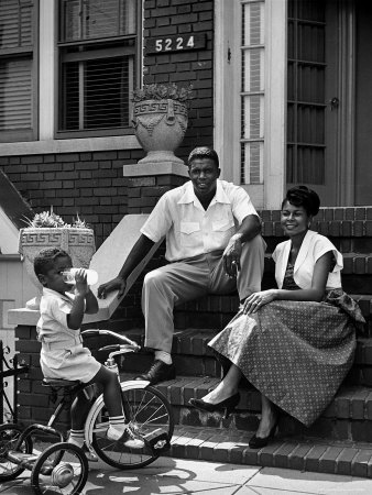 Baseball Star Jackie Robinson With Wife Rachel As Son Jackie Jr. Drinks A Glass Of Milk by Nina Leen Pricing Limited Edition Print image